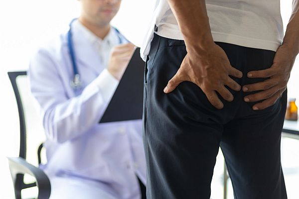 Man having butt pain and hemorrhoids.